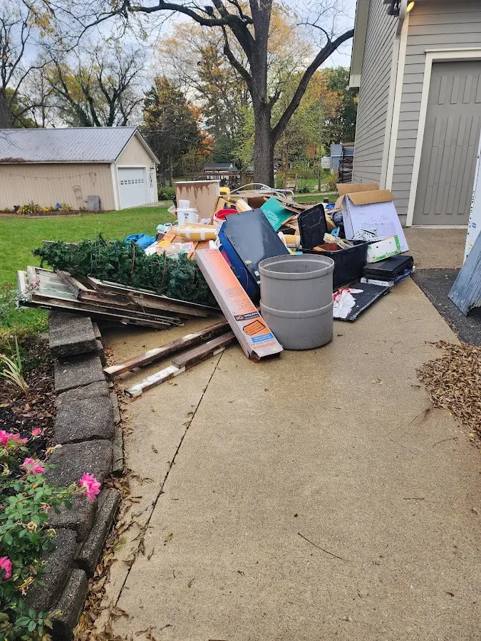 Dumpster being loaded with debris for Roofing Dumpster Rental in Watervliet